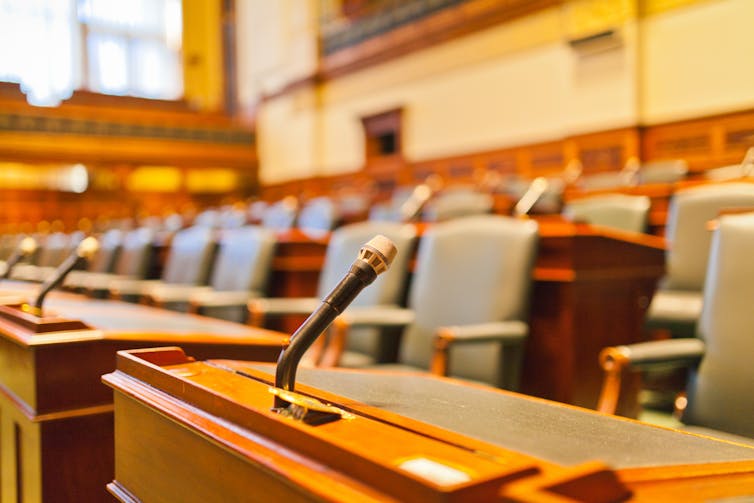 Courtroom, zoomed in on chairs with microphones.