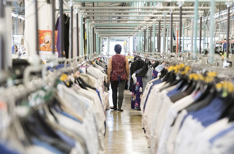 A garment worker walks through a clothing factory