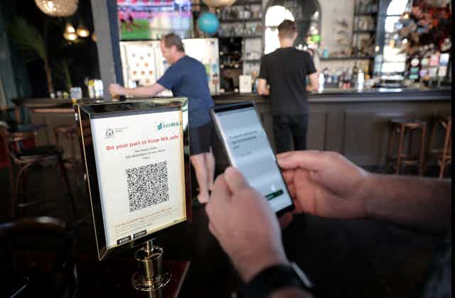 Close-up of someone scanning a QR code with the SafeWA app