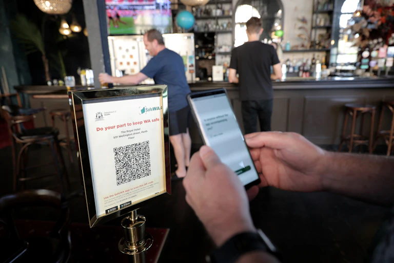 Close-up of someone scanning a QR code with the SafeWA app