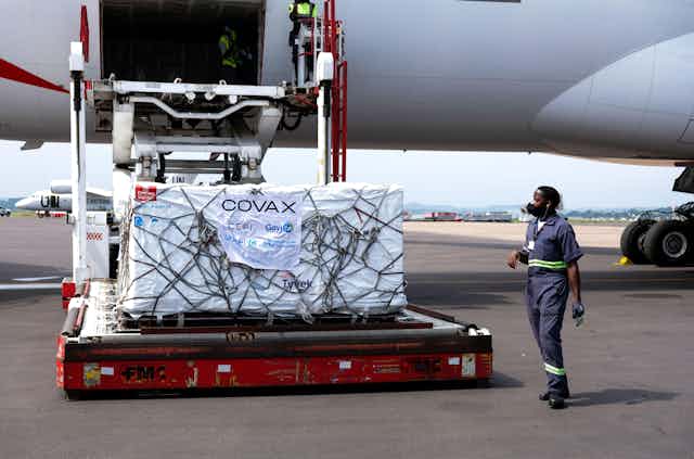 AstraZeneca vaccines from Covax vaccine sharing programme being unloaded from a plane at Entebbe International Airport, Uganda