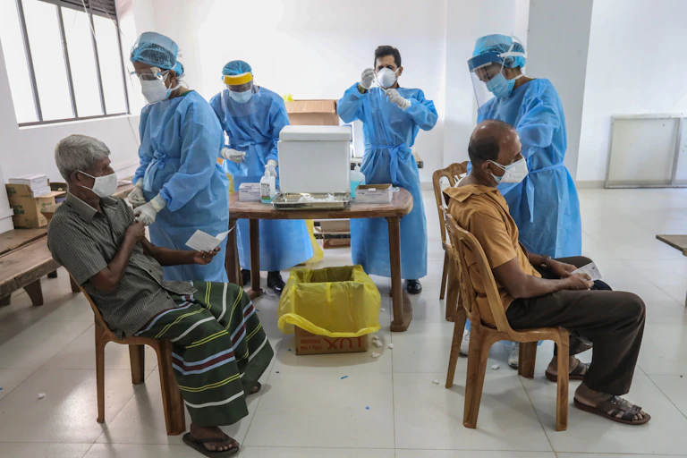 People receive the second dose of China's Sinopharm COVID-19 vaccine at a temporary vaccination center in Colombo, Sri Lanka, 16 June 2021