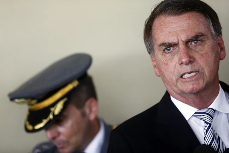 Jair Bolsonaro with a military escort behind him.