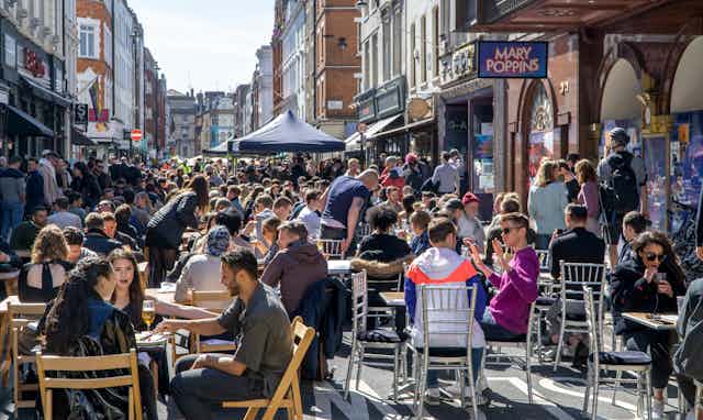 People eating and drinking outside in Soho, London