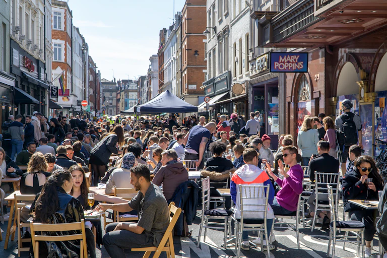People eating and drinking outside in Soho, London