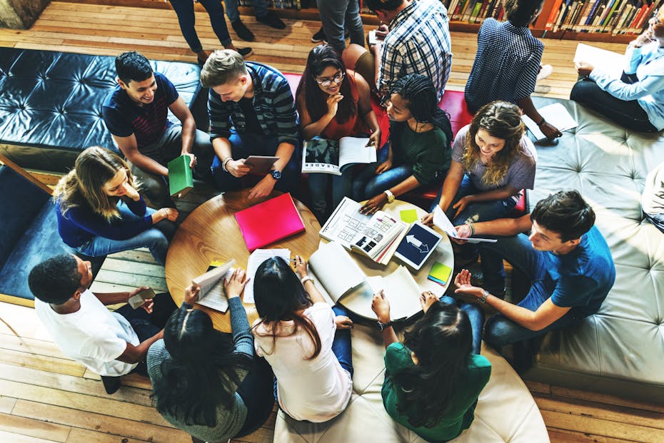 A group of students sit studying in a classroom