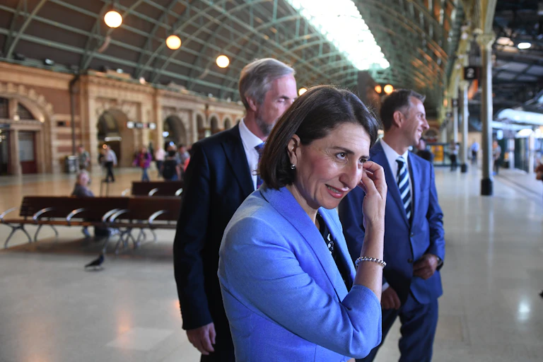 Woman and two men in suits in train station