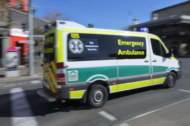 Ambulance rushing off to emergency along city street