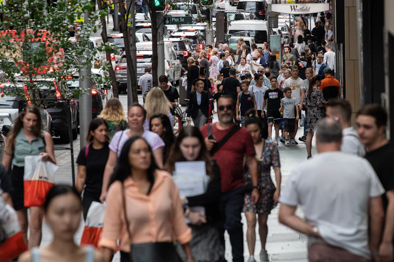 Crowd walking along street.