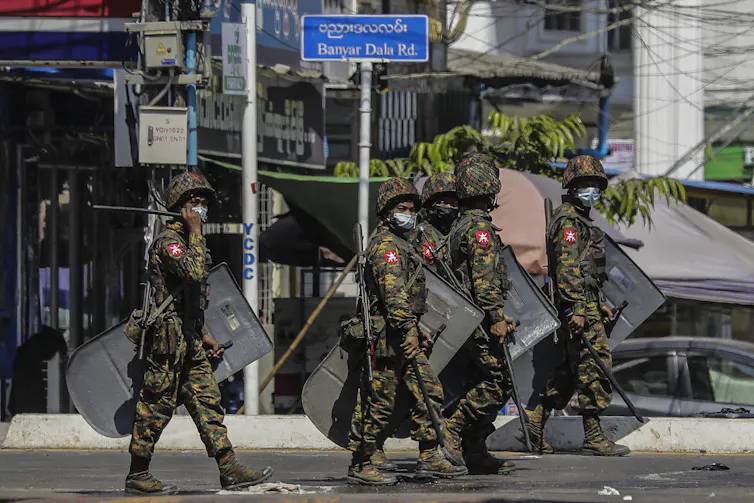 Members of Myanmar military patrol the streets of Yangon, March 2021.