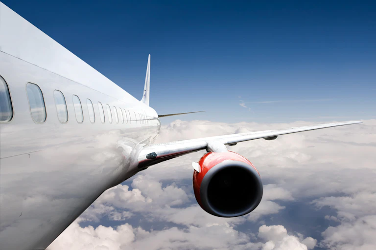 A lateral view of an aeroplane fuselage during flight.