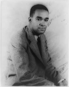 A black and white portrait of author Richard Wright, pictured seated.