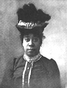 Pauline Hopkins poses for a portrait wearing a hat.