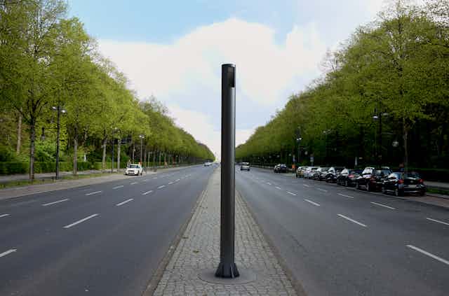smart light pole in the middle of a tree-lined street