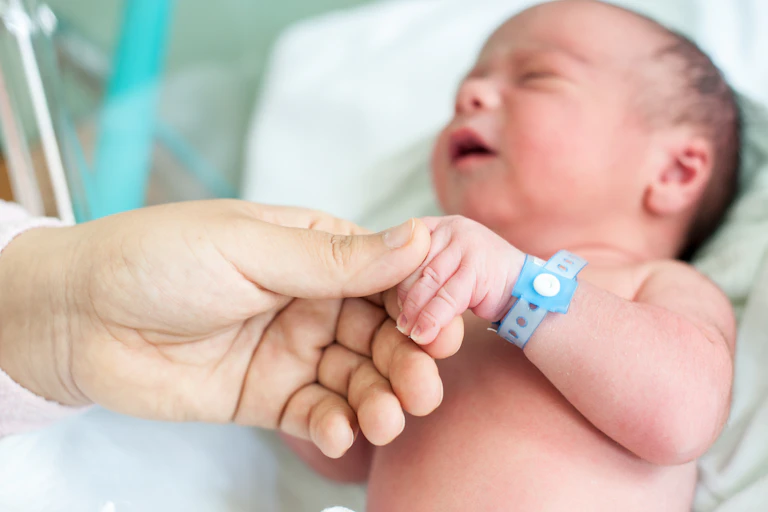 Newborn holding hand