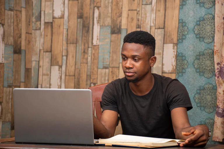 A young man works at his laptop