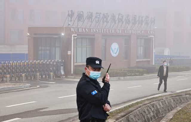 A security guard outside the front entrance of the Wuhan Institute of Virology
