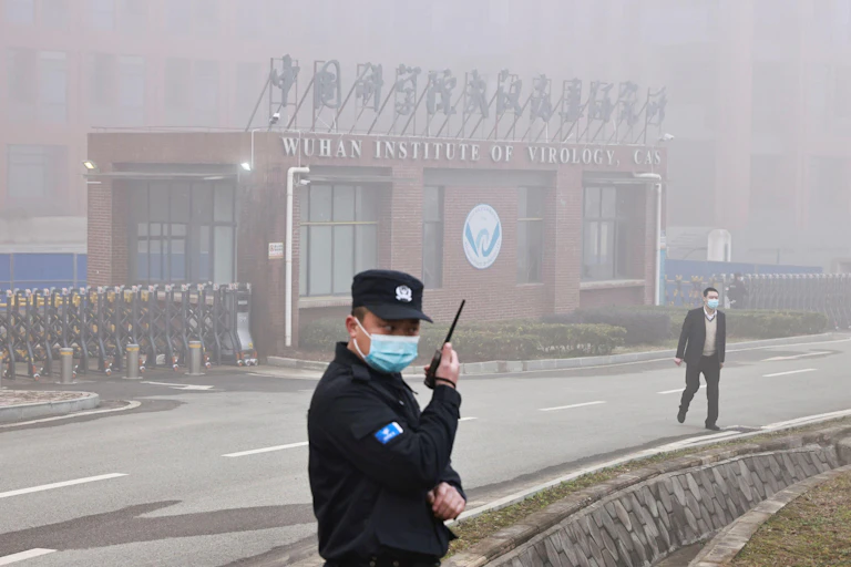 A security guard outside the front entrance of the Wuhan Institute of Virology