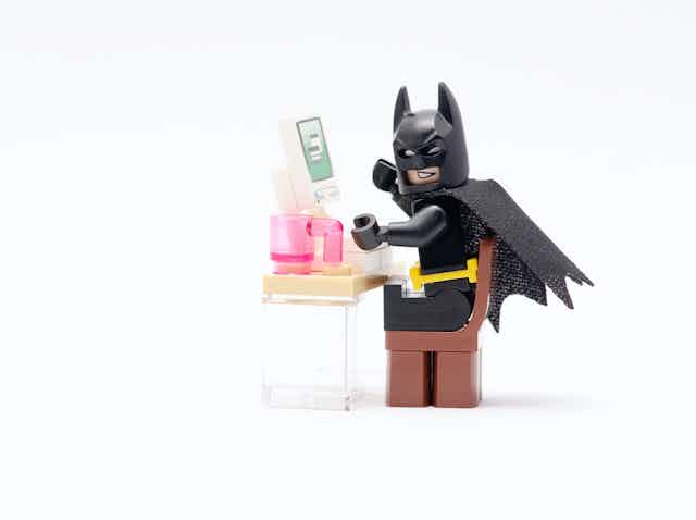 LEGO batman in front of a computer