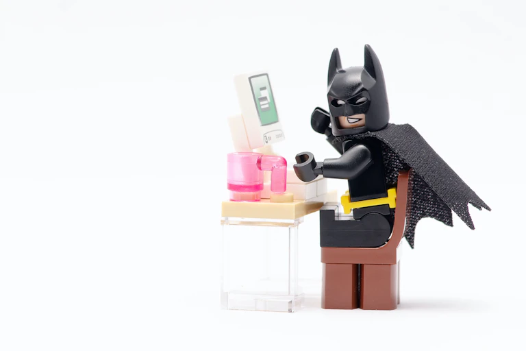 LEGO batman in front of a computer