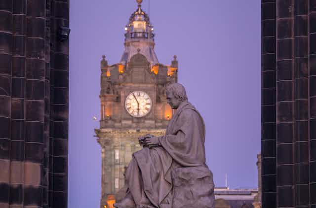 Statue of Walter Scott beneath the Scott Monument on Princes Street Edinburgh.