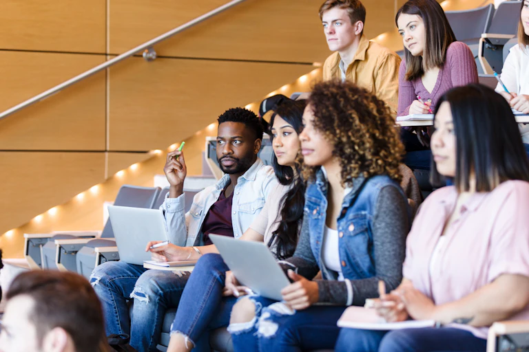 A man talks to a group of college students.