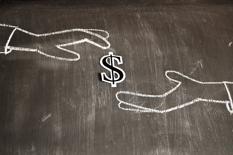 Chalk outline of two hands exchanging money