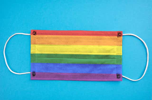 LGBTQ rainbow facemark against a blue background