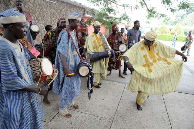 A man dances while others are playing traditional drums during a festival at the University of Ibadan, Oyo State, Nigeria on June 27, 2011.