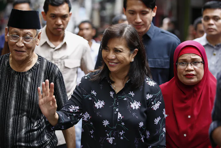 Vice-president of the Philippines, Leni Robredo, smiles and waves at supporters while visiting Quezon City, east of Manila, 2019.