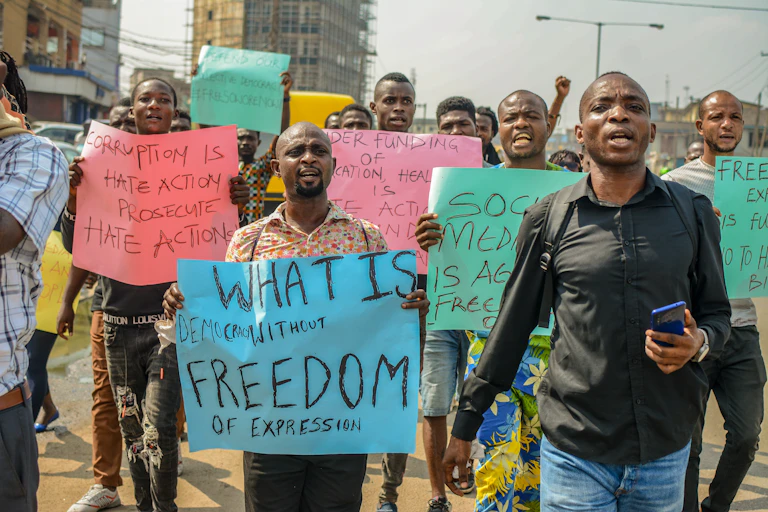 People holding placards, protesting against a gag on social media.