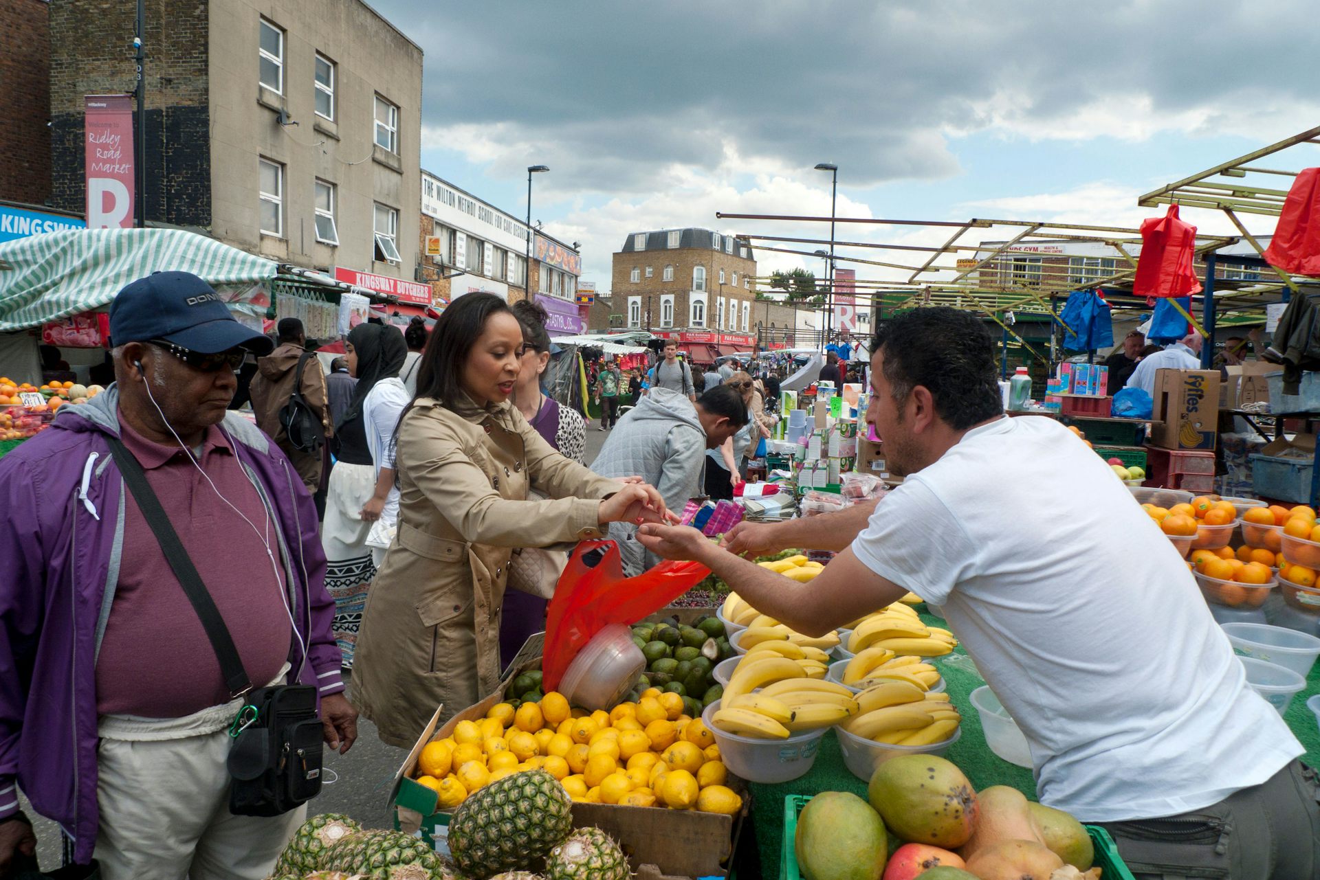 Woman pays for produce at market.