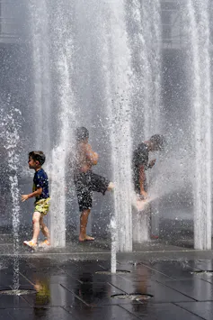 Children playing in a water fountain