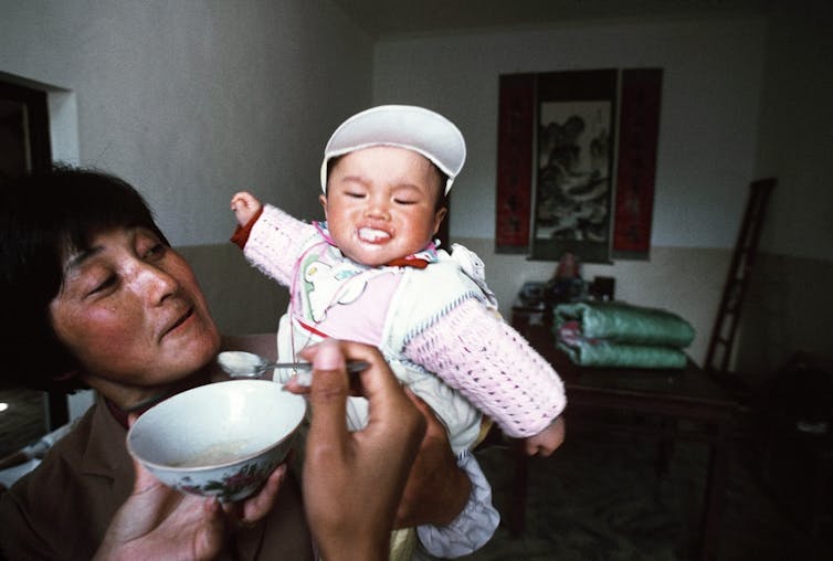 A baby is fed by its mother