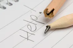 The word 'help' is written in pencil and the pencil nib is snapped.