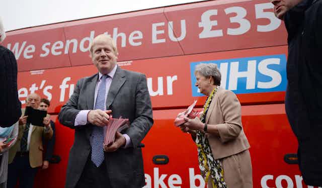 Boris Johnson standing in front of the "Vote Leave" campaign bus, which claims the UK sends 350 million pounds weekly to the EU, which could be used to fund the NHS.