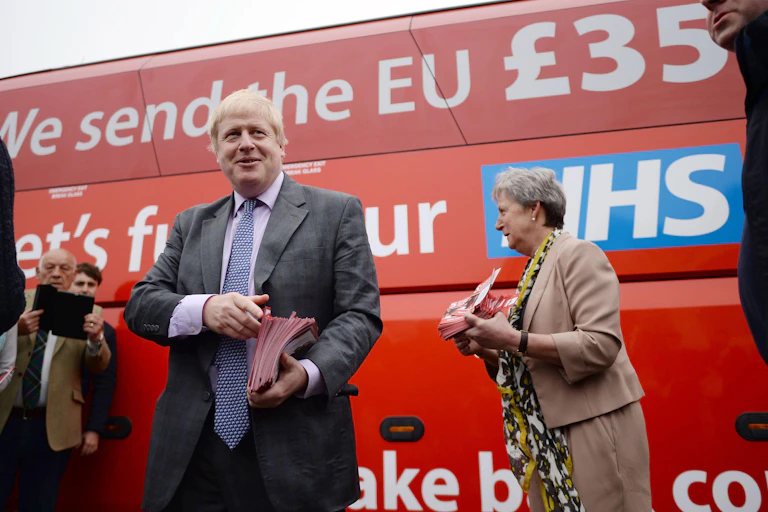 Boris Johnson standing in front of the "Vote Leave" campaign bus, which claims the UK sends 350 million pounds weekly to the EU, which could be used to fund the NHS.