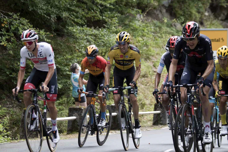 Racers in the Tour de France struggling up a hill.