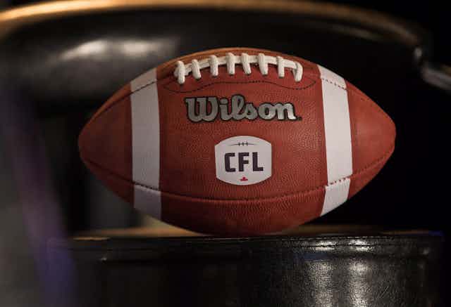 An official CFL football made by Wilson sits on a table