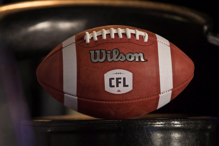 An official CFL football made by Wilson sits on a table