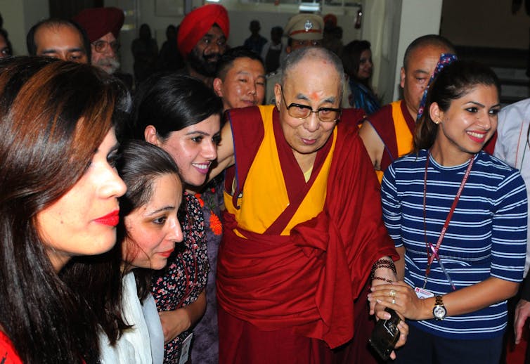 Students interact with the Dalai Lama during a visit to Chandigarh University at Mohali, in northern India.
