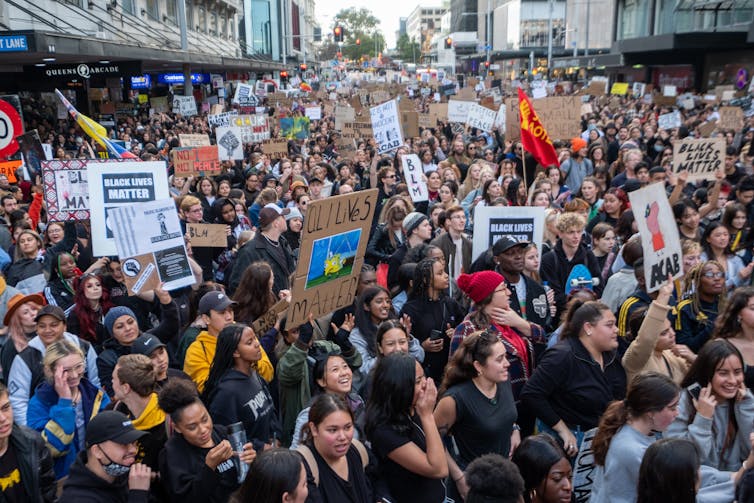 People listening to speeches at a Black Lives Matter rally in Auckland
