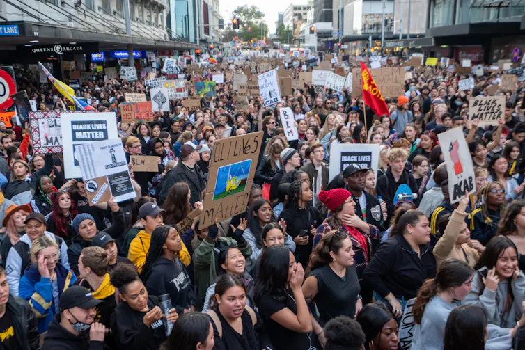 People listening to speeches at a Black Lives Matter rally in Auckland