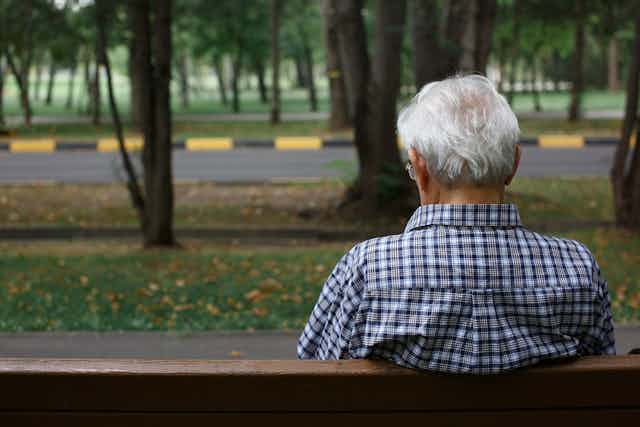 Older man sitting on a park bench