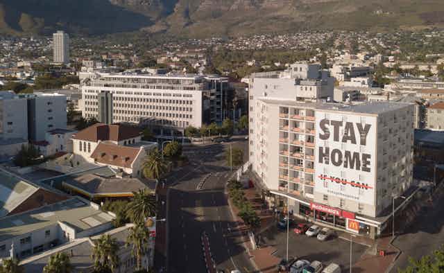 Cape Town during lockdown, with a sign on a building saying 'Stay Home'