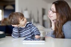 A woman speaking to her young child.