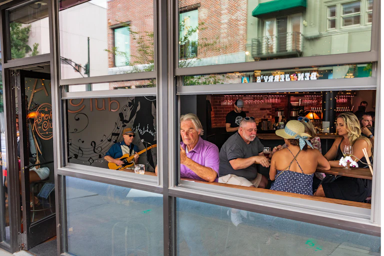 People sitting in a bar with the window open