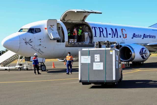 A shipment of COVID-19 vaccines being unloaded from a plane