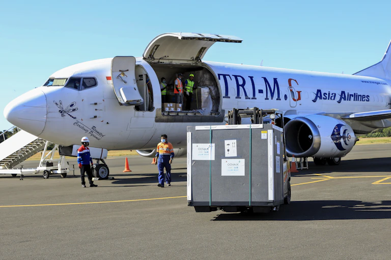 A shipment of COVID-19 vaccines being unloaded from a plane