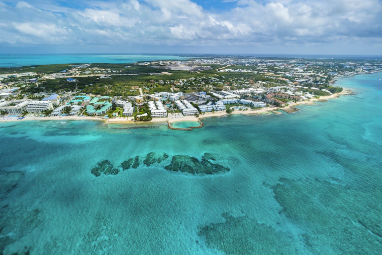 A relatively small island with luxury resorts along the short sits in the turquoise waters of the Caribbean